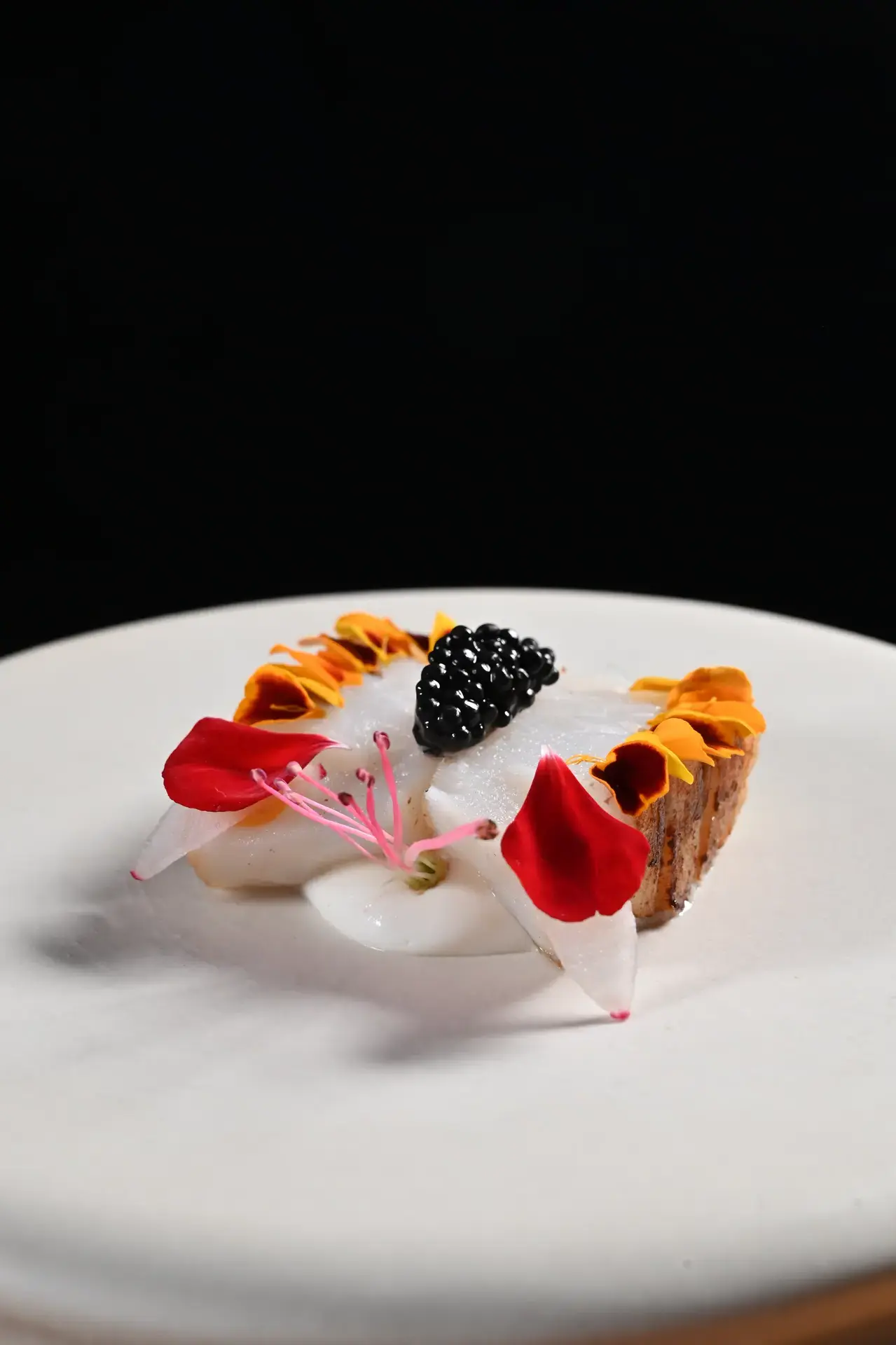 Signature dish with caviar and edible flowers