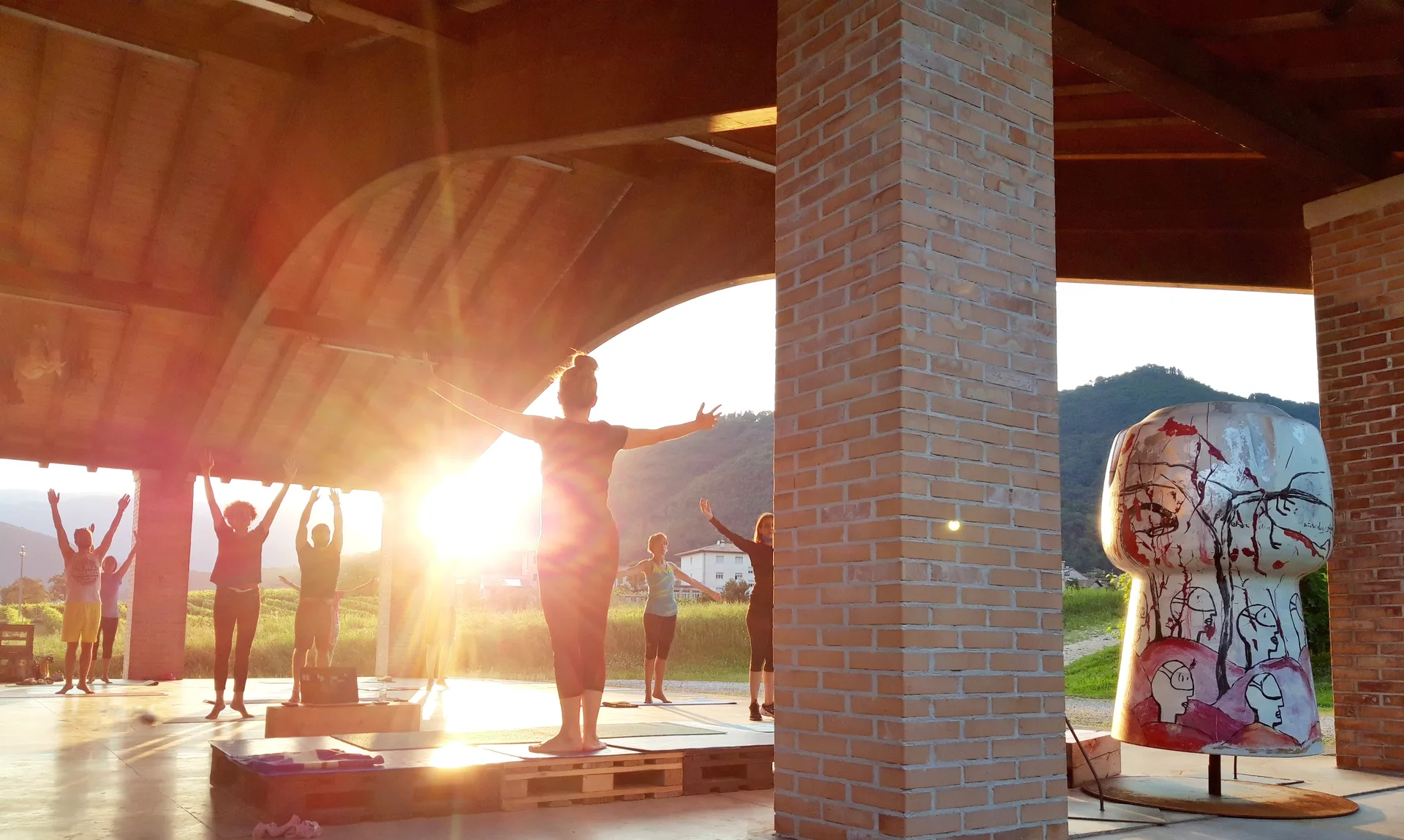 Yoga session at sunset among the sculptures of the Borgo