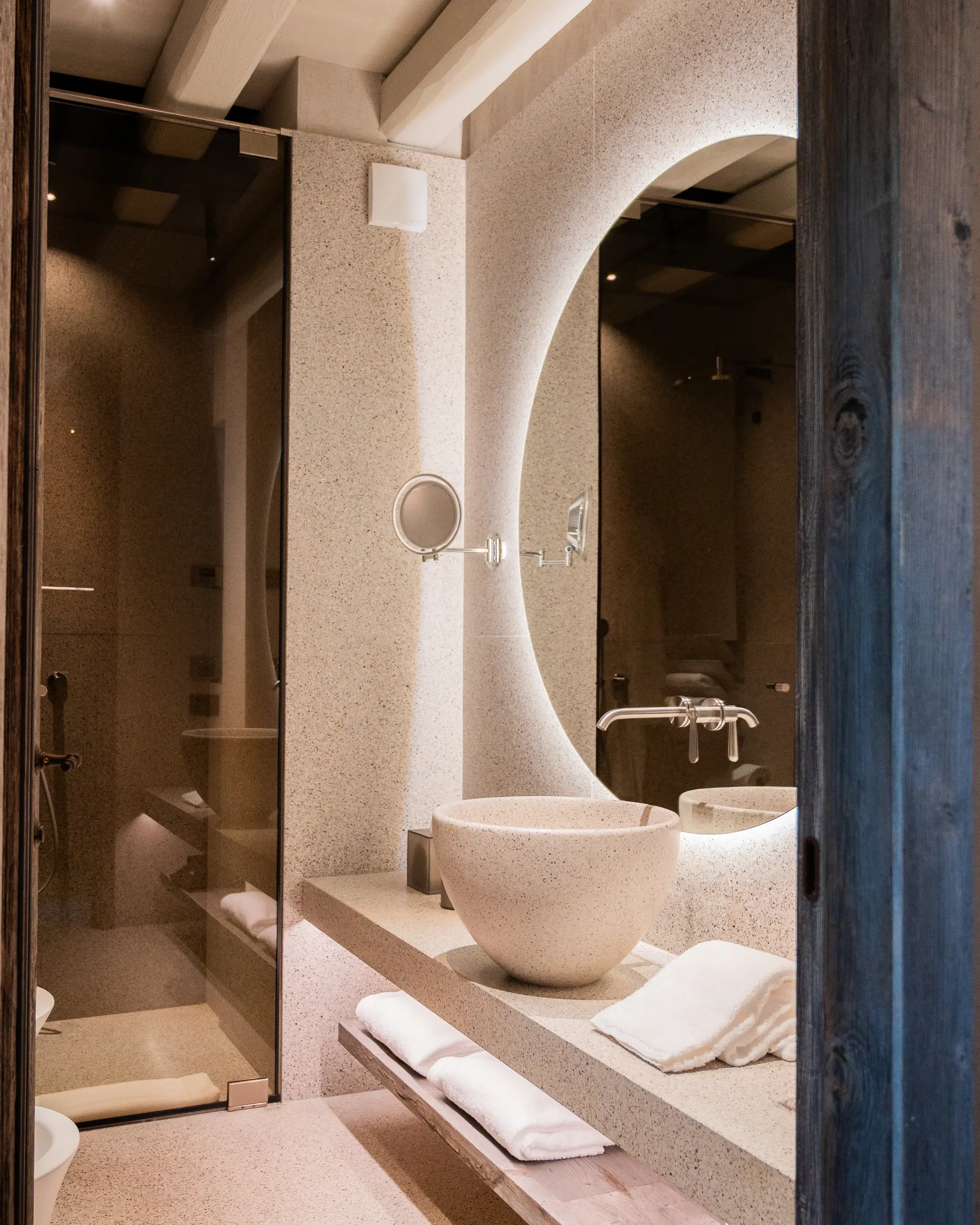 Deluxe Room — bathroom in Venetian seminato with backlit mirror and brushed-brass fittings at Borgo Taurino